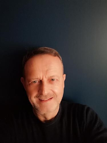 owner profile picture. Green eyes and black shirt